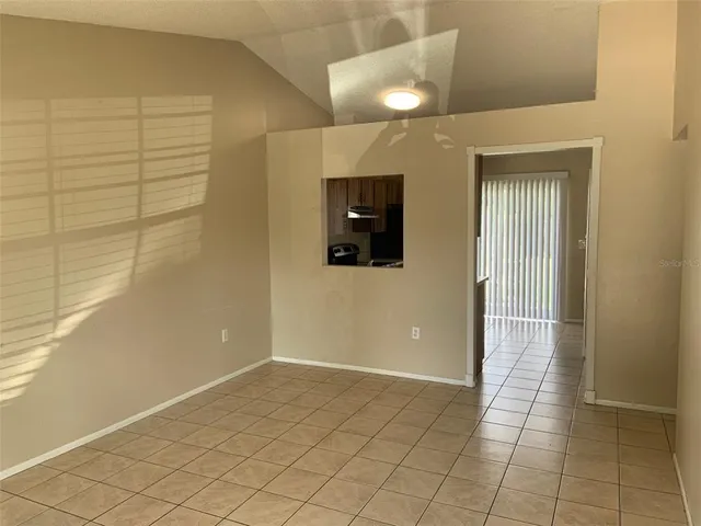 a view of a hallway with wooden floor and chair