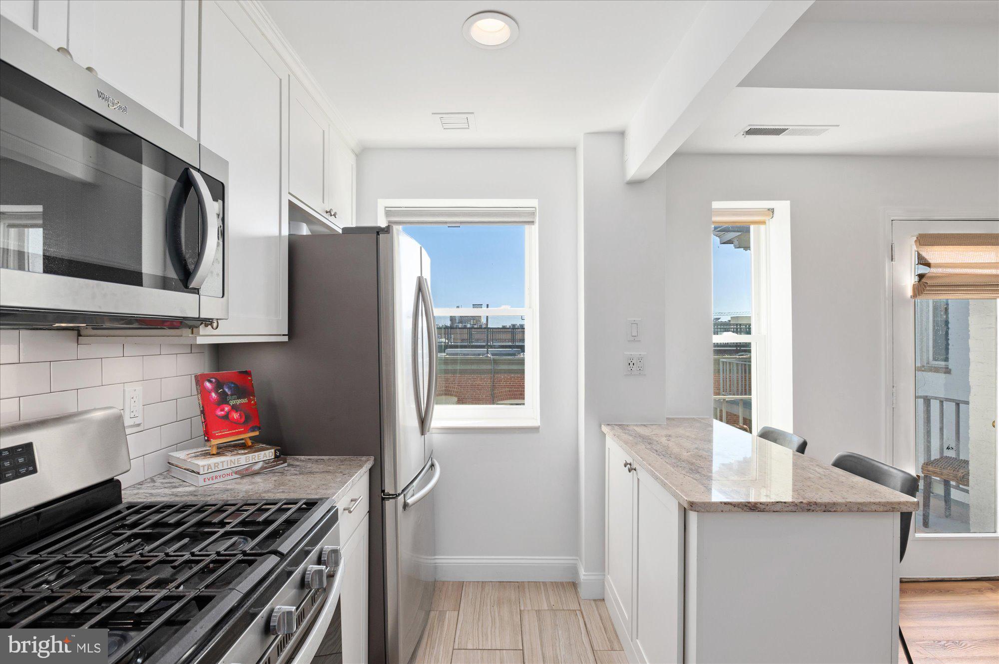 2127 California Street Northwest, Unit 803 Washington, DC 20008 - Photo 11 of 22 a kitchen with stainless steel appliances a stove and cabinets