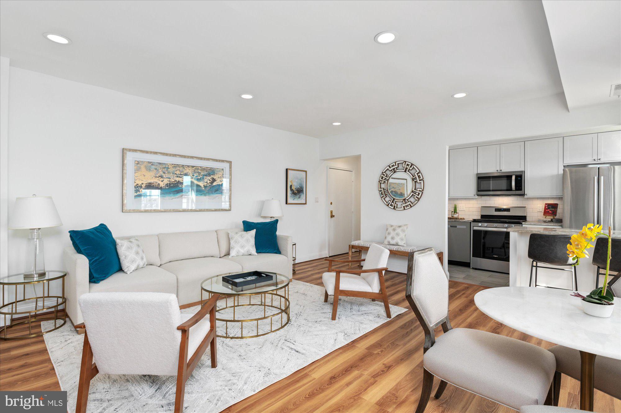 2127 California Street Northwest, Unit 803 Washington, DC 20008 - Photo 13 of 22 a living room with furniture a flat screen tv and kitchen view