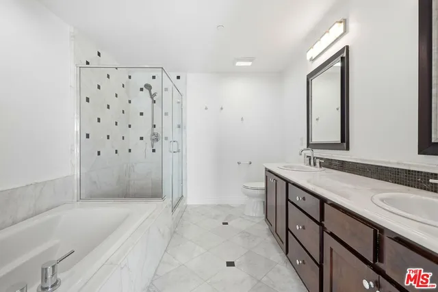 a bathroom with a bathtub sink vanity and mirror