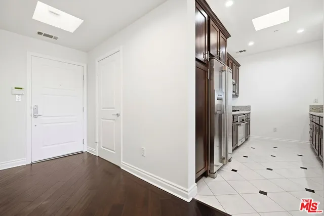 a view of hallway with stairs and wooden floor