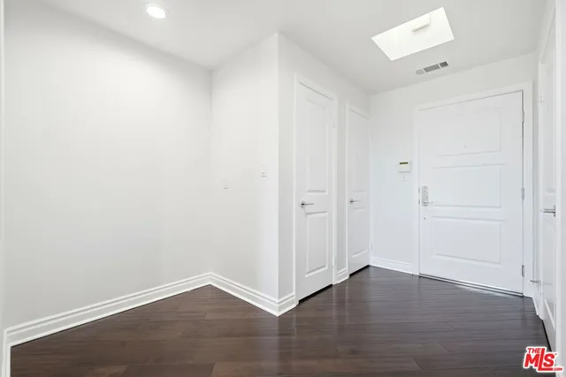 an empty room with wooden floor
