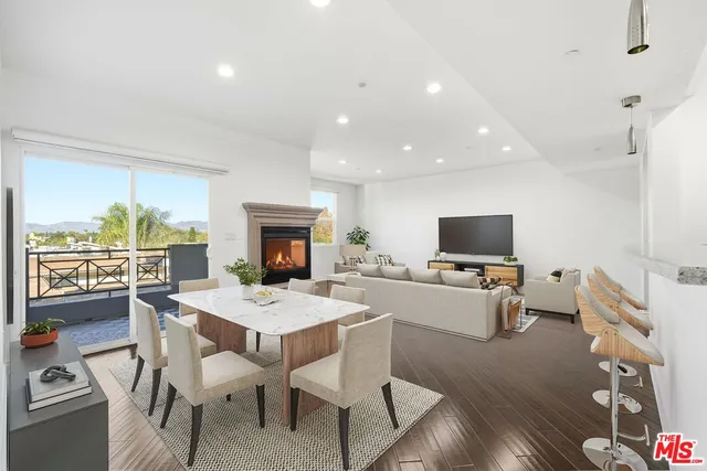 a view of a dining room with furniture wooden floor and a flat screen tv