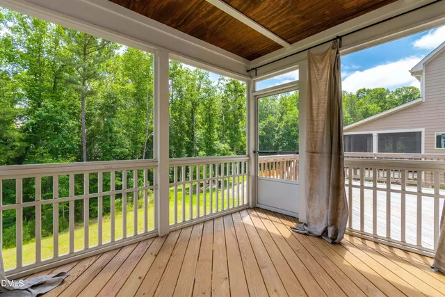 a view of a balcony with wooden floor