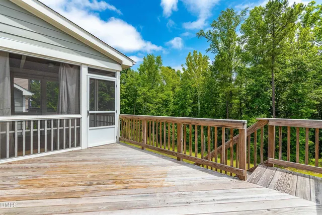 a view of balcony with wooden floor and fence