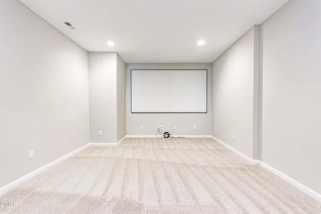a view of a room with a sink and a mirror