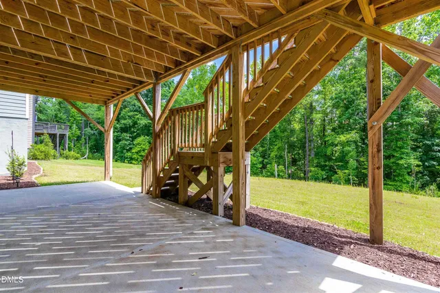 a view of a couches in the patio with a backyard