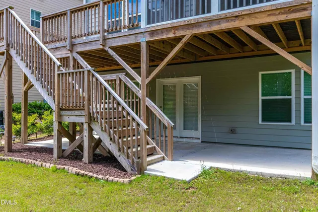a view of deck with patio and a yard