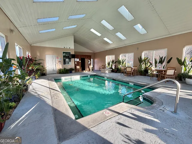 a living room with lots of furniture and a table