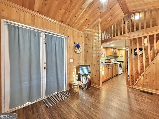 a view of a livingroom with wooden floor and furniture