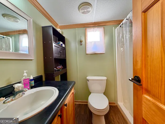 a bathroom with a toilet sink and mirror