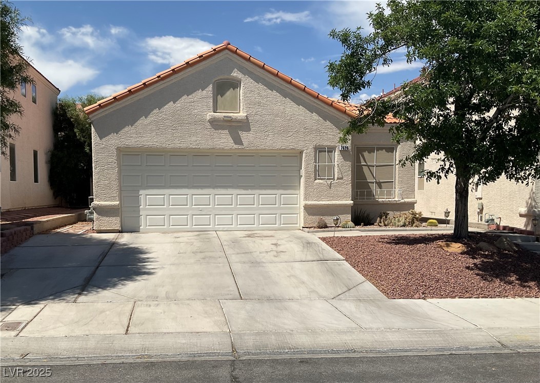 7620 Donald Nelson Avenue Las Vegas, NV 89131 - Photo 3 of 34 View of front of home featuring stucco siding, concrete driveway, a tile roof, and a garage