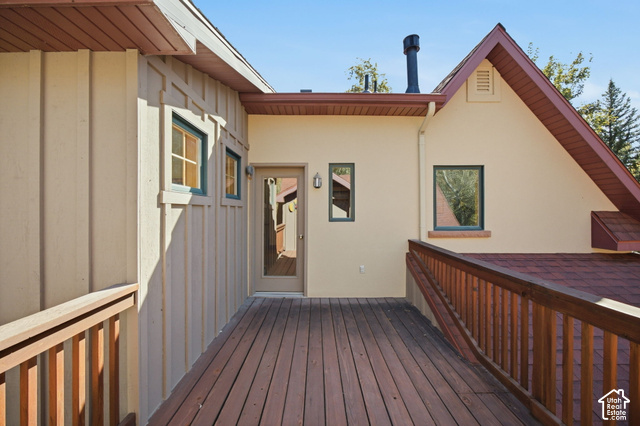 725 Canyon Road Smithfield, UT 84335 - Photo 67 of 100 Expansive wood-finish decking with wood railings, board-and-batten siding, stucco exterior, and a gabled roofline