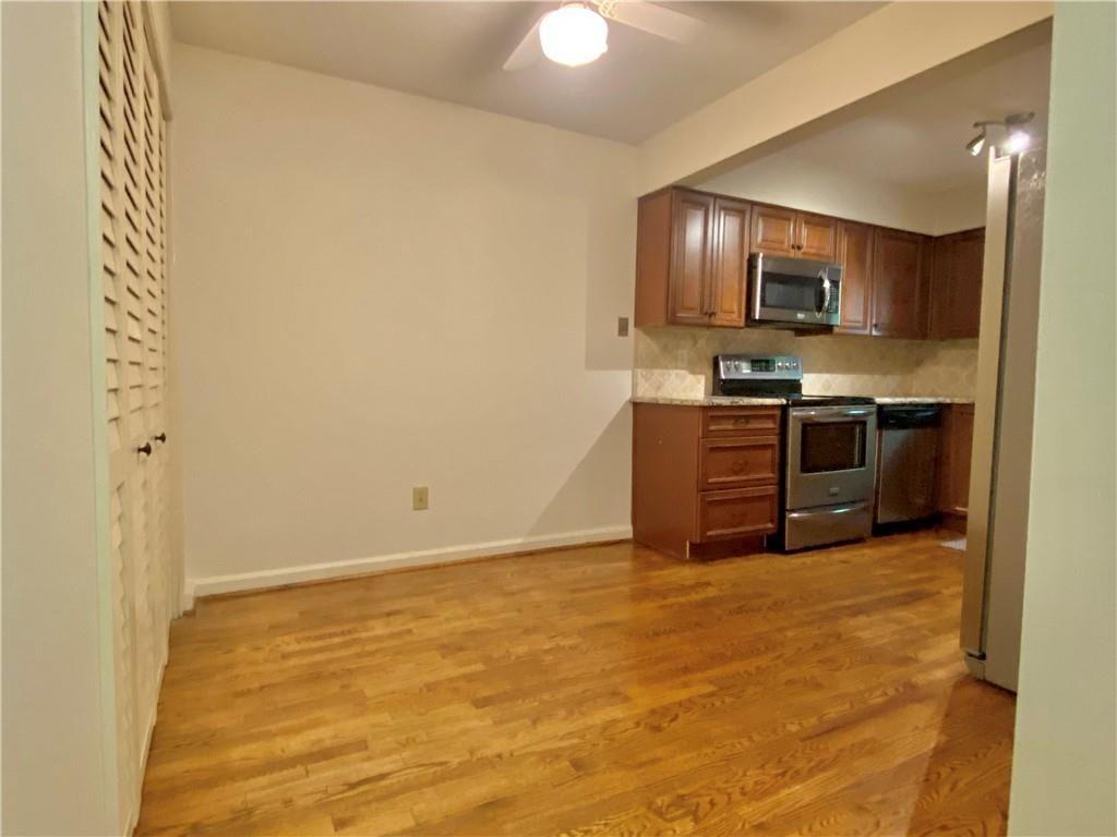 1148 Riverbend Club Drive Southeast Atlanta, GA 30339 - Photo 11 of 51 a view of kitchen with stainless steel appliances granite countertop a stove top oven a sink and dishwasher