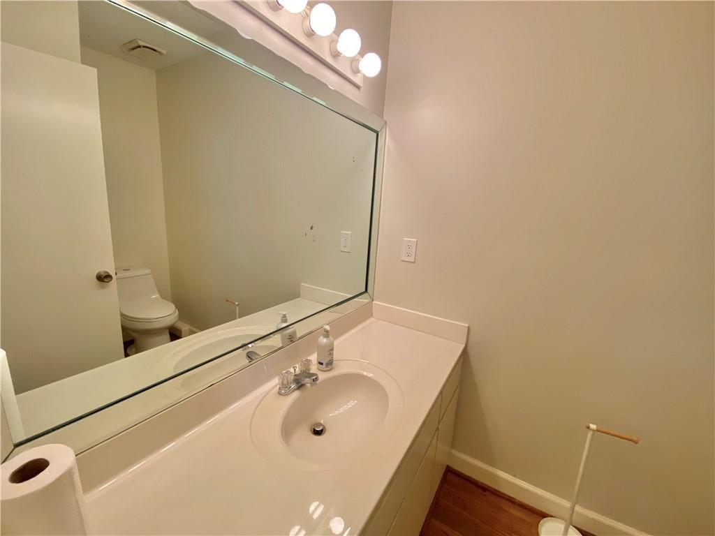 1148 Riverbend Club Drive Southeast Atlanta, GA 30339 - Photo 18 of 51 a bathroom with a sink and a mirror