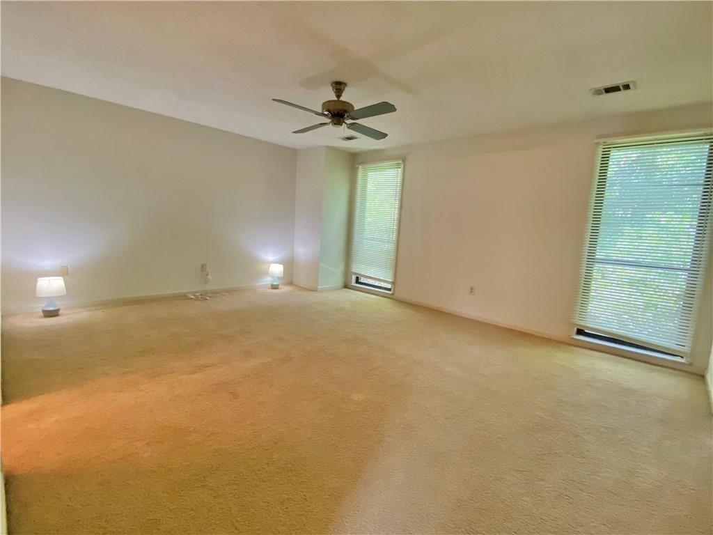 1148 Riverbend Club Drive Southeast Atlanta, GA 30339 - Photo 23 of 51 an empty room with a ceiling fan and window