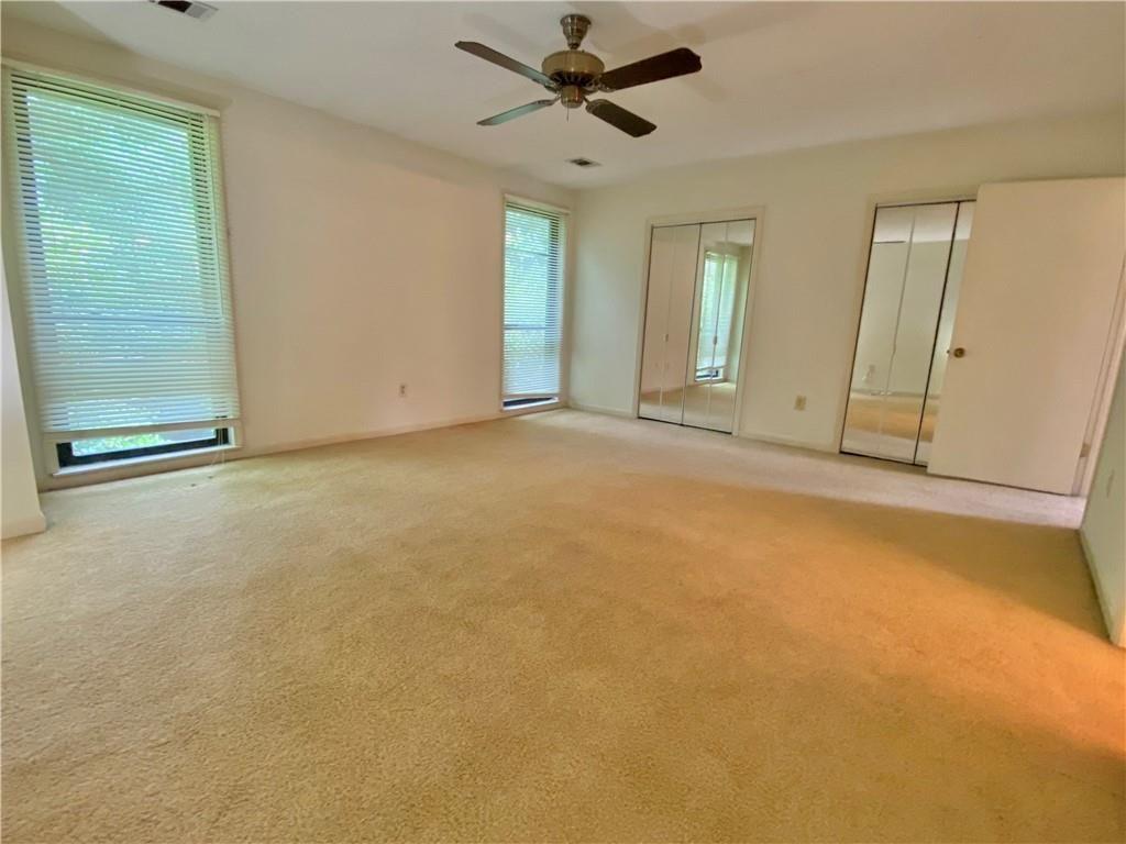 1148 Riverbend Club Drive Southeast Atlanta, GA 30339 - Photo 24 of 51 an empty room with windows and fan