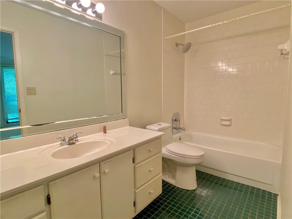 1148 Riverbend Club Drive Southeast Atlanta, GA 30339 - Photo 26 of 51 a bathroom with a sink a toilet and shower