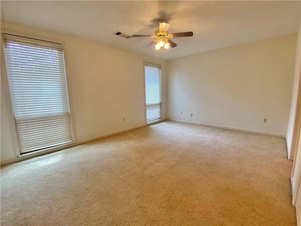 1148 Riverbend Club Drive Southeast Atlanta, GA 30339 - Photo 30 of 51 a view of an empty room with a chandelier fan