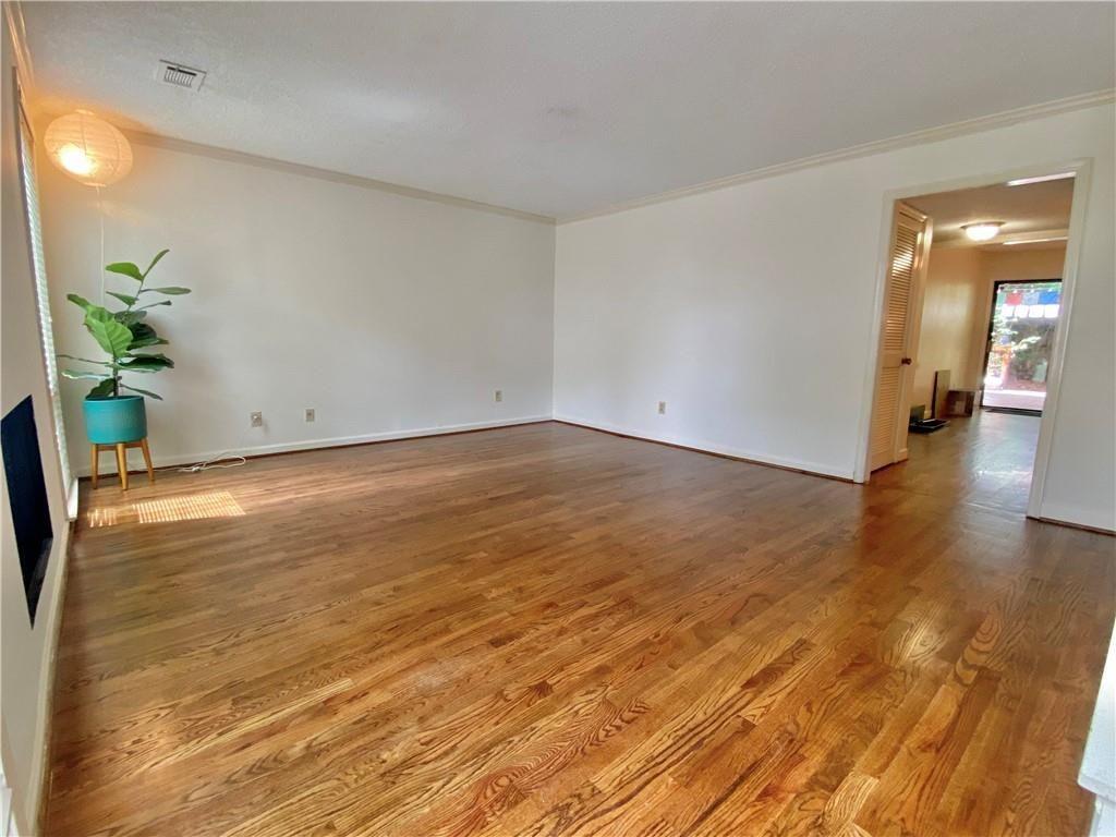 1148 Riverbend Club Drive Southeast Atlanta, GA 30339 - Photo 3 of 51 a view of a room with wooden floor and a potted plant