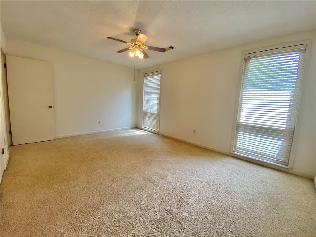 1148 Riverbend Club Drive Southeast Atlanta, GA 30339 - Photo 31 of 51 a view of an empty room with a chandelier fan