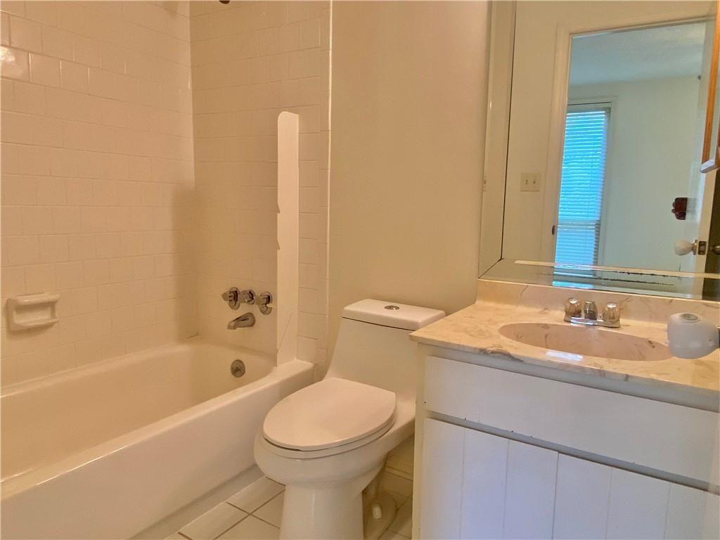 1148 Riverbend Club Drive Southeast Atlanta, GA 30339 - Photo 32 of 51 a bathroom with a sink a toilet and shower