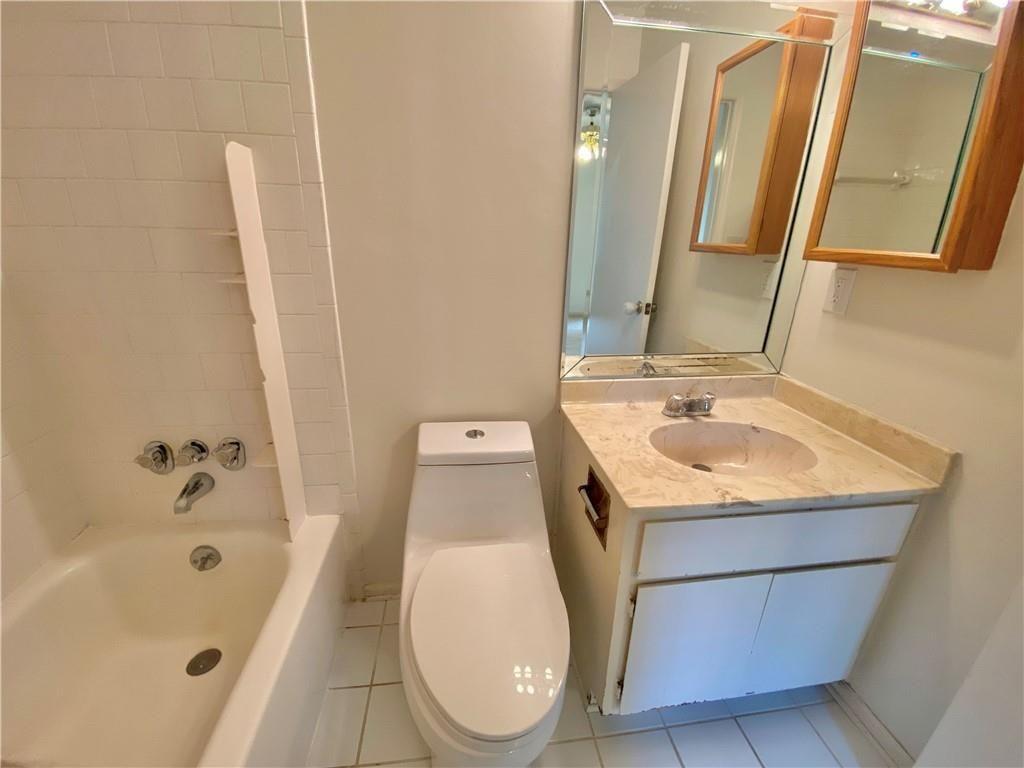 1148 Riverbend Club Drive Southeast Atlanta, GA 30339 - Photo 33 of 51 a bathroom with a sink a toilet and mirror