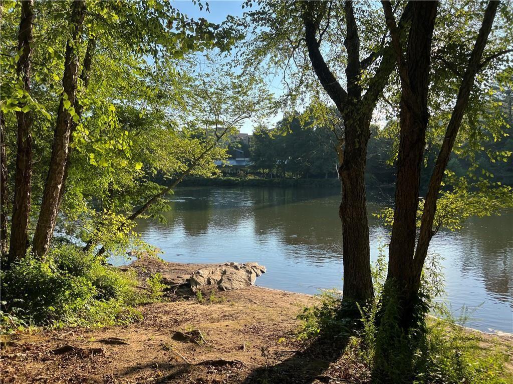 1148 Riverbend Club Drive Southeast Atlanta, GA 30339 - Photo 43 of 51 a view of a lake in between two trees