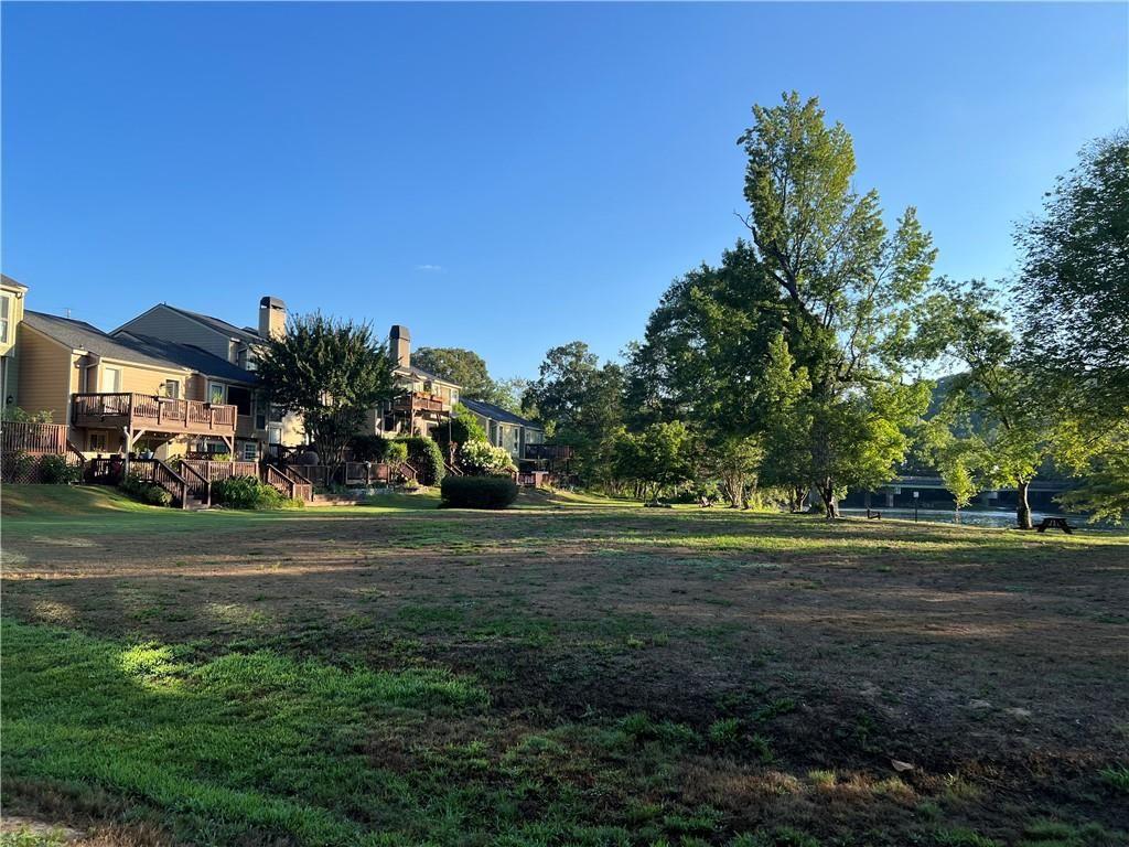 1148 Riverbend Club Drive Southeast Atlanta, GA 30339 - Photo 50 of 51 a front view of a house with a yard and trees