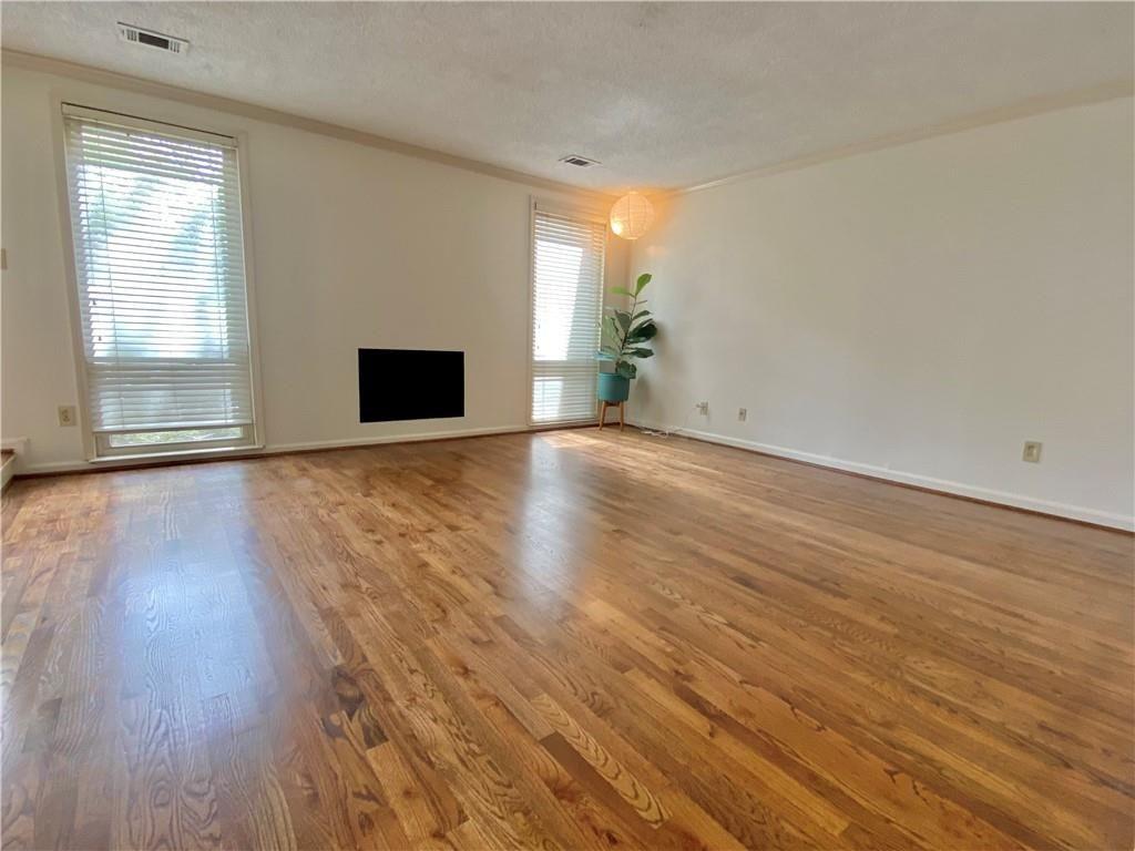 1148 Riverbend Club Drive Southeast Atlanta, GA 30339 - Photo 5 of 51 a view of an empty room with wooden floor and a window
