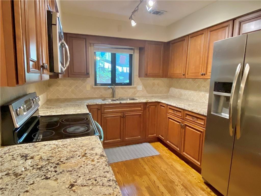 1148 Riverbend Club Drive Southeast Atlanta, GA 30339 - Photo 7 of 51 a kitchen with granite countertop a refrigerator stove and sink