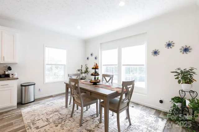 a dining room with furniture window and wooden floor