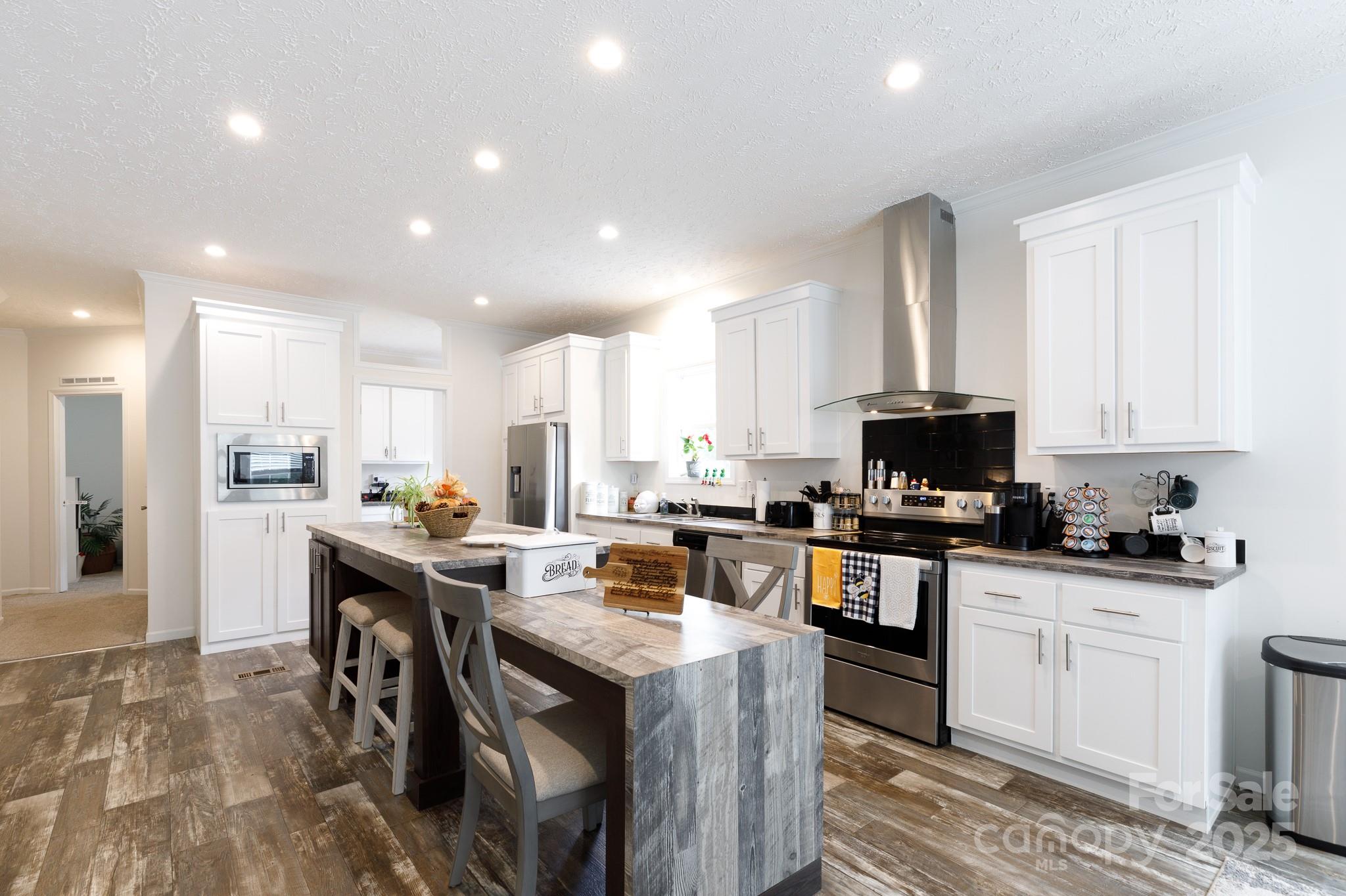 4575 Cureton Ferry Road Catawba, SC 29704 - Photo 12 of 42 a kitchen with stainless steel appliances a stove a sink a oven a center island and a refrigerator