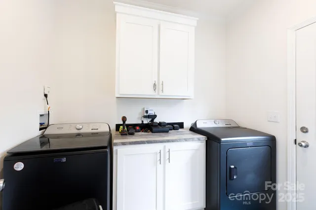 a utility room with sink dryer and washer