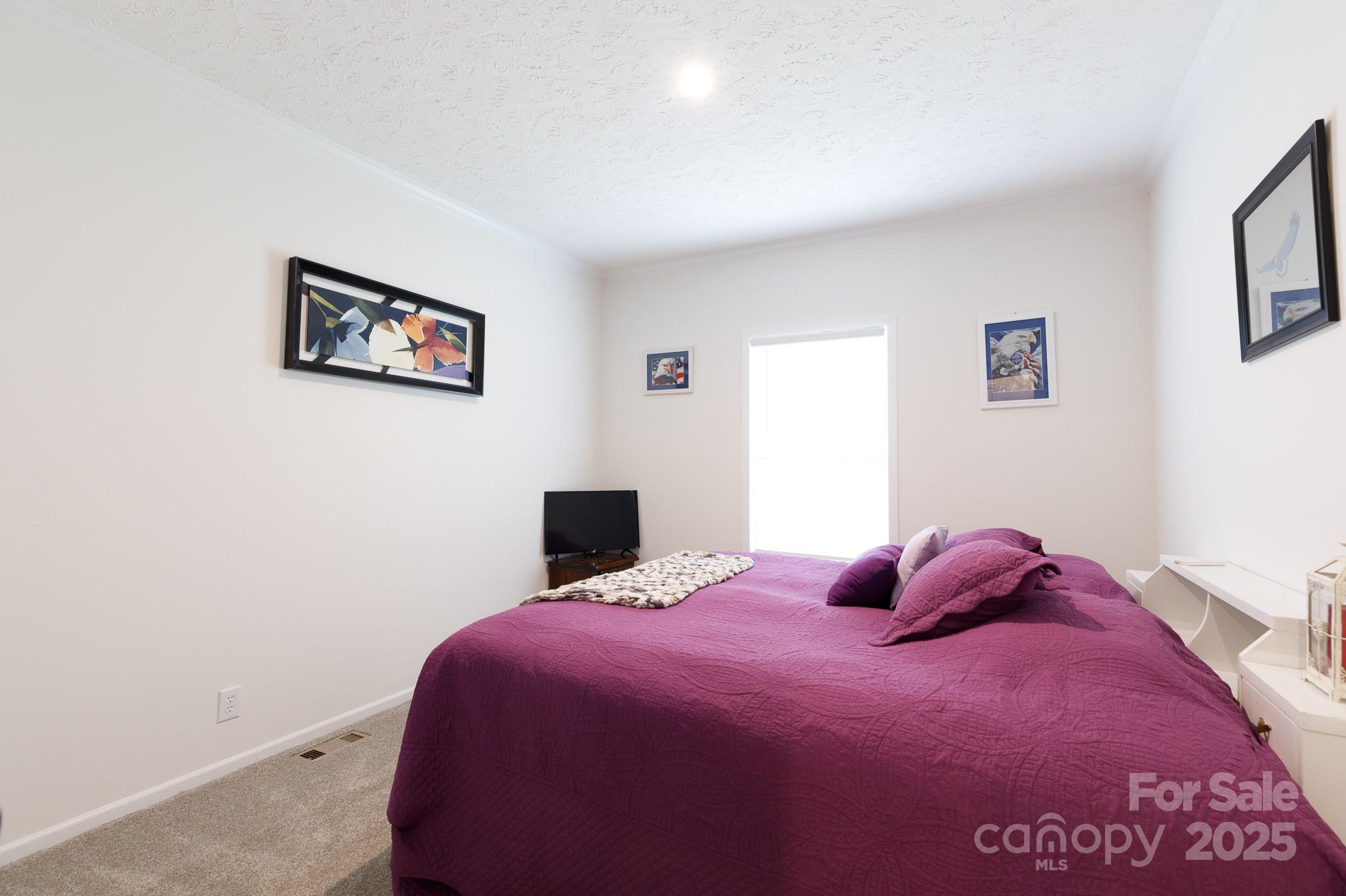 4575 Cureton Ferry Road Catawba, SC 29704 - Photo 22 of 42 a bedroom with a bed and a wall painting