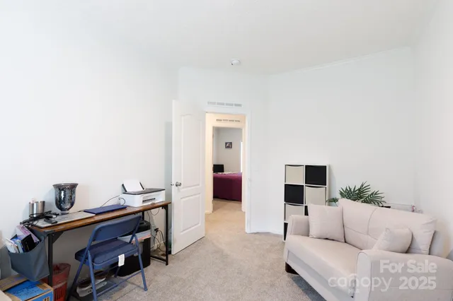 a living room with furniture and a lamp