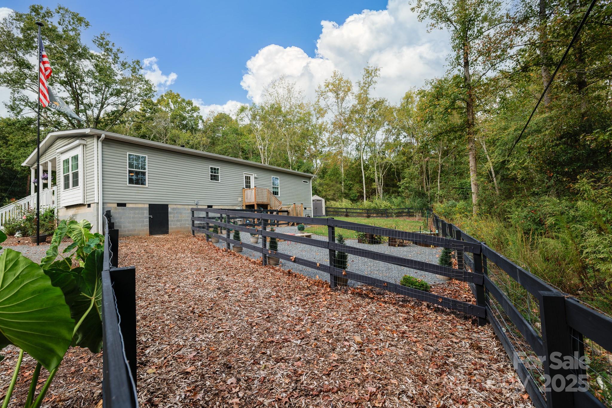 4575 Cureton Ferry Road Catawba, SC 29704 - Photo 35 of 42 a view of a house with a yard and wooden fence