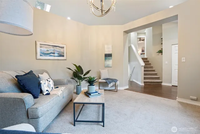 a living room with furniture and a potted plant