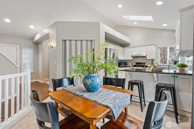 a kitchen with a dining table chairs and kitchen view