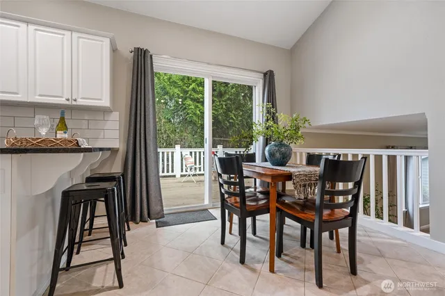 a view of a dining room with furniture and chandelier