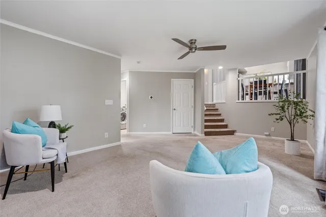 a living room with furniture and a potted plant
