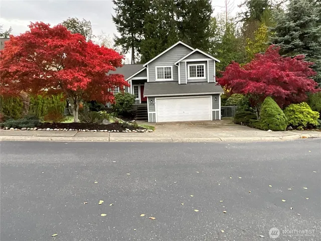 a front view of a house with a yard and garage