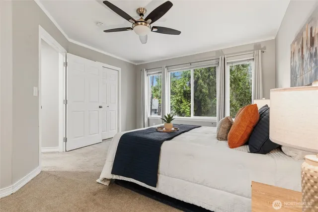 a bedroom with a bed and a large window