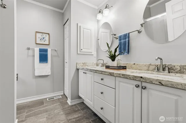a bathroom with double sink and a mirror