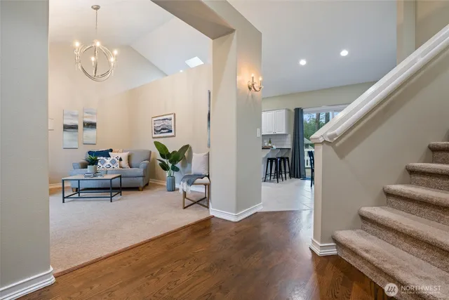 a living room with furniture and a chandelier