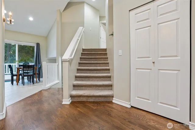 a view of entryway and hall with wooden floor