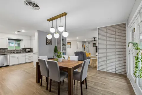 a view of a dining room with furniture and wooden floor
