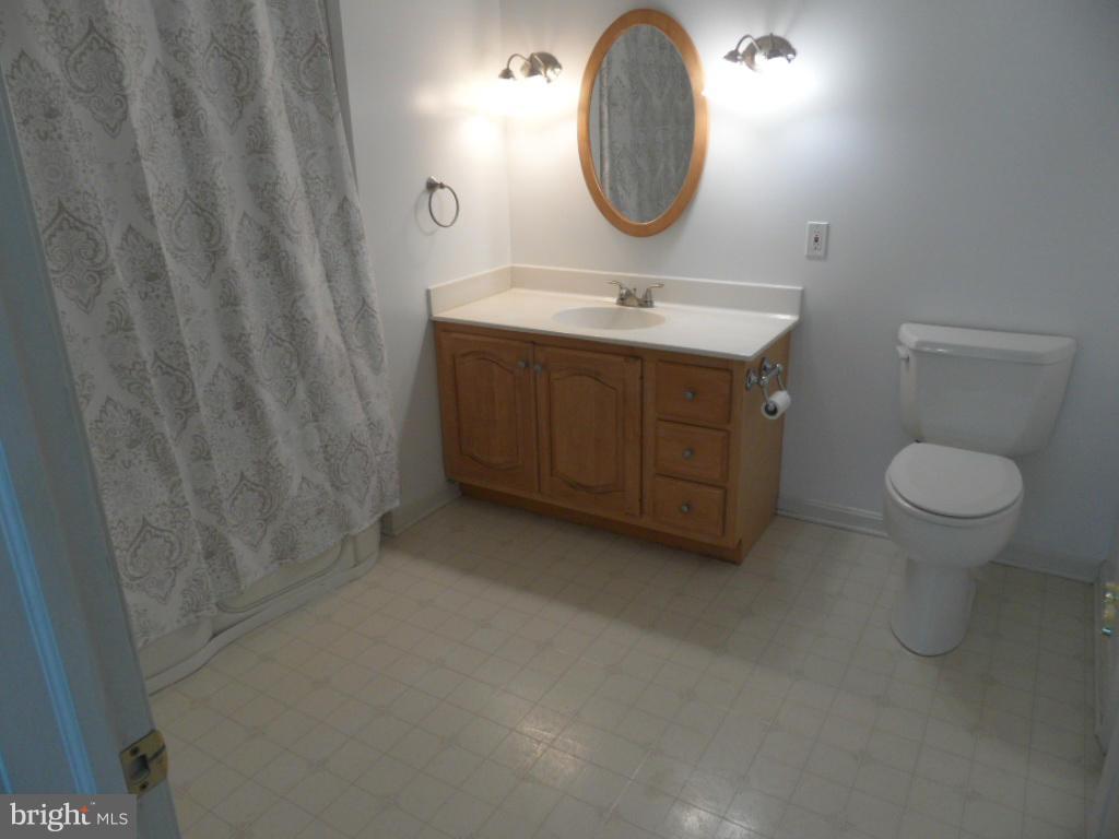 1709 Oakmont Road Fallston, MD 21047 - Photo 12 of 30 a bathroom with a toilet a sink and a mirror