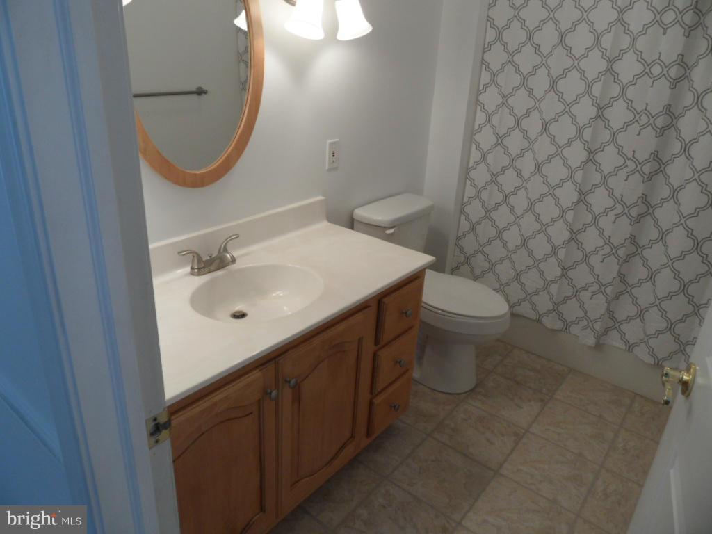1709 Oakmont Road Fallston, MD 21047 - Photo 15 of 30 a bathroom with a sink a toilet and mirror