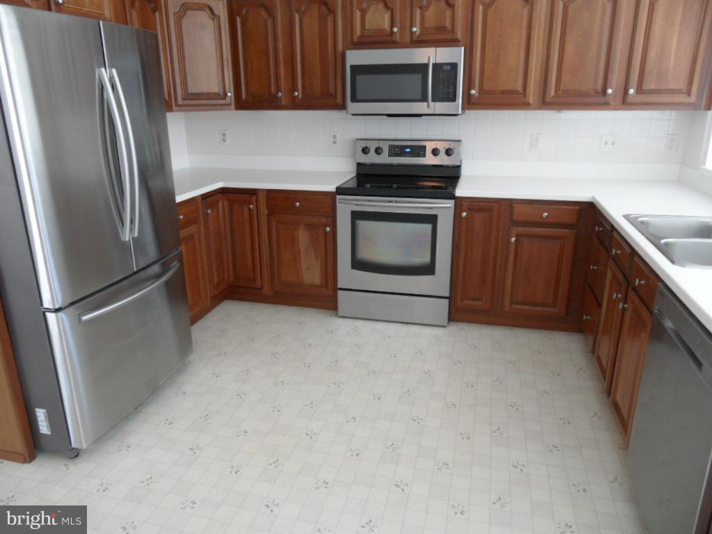1709 Oakmont Road Fallston, MD 21047 - Photo 8 of 30 a kitchen with a refrigerator stove and microwave